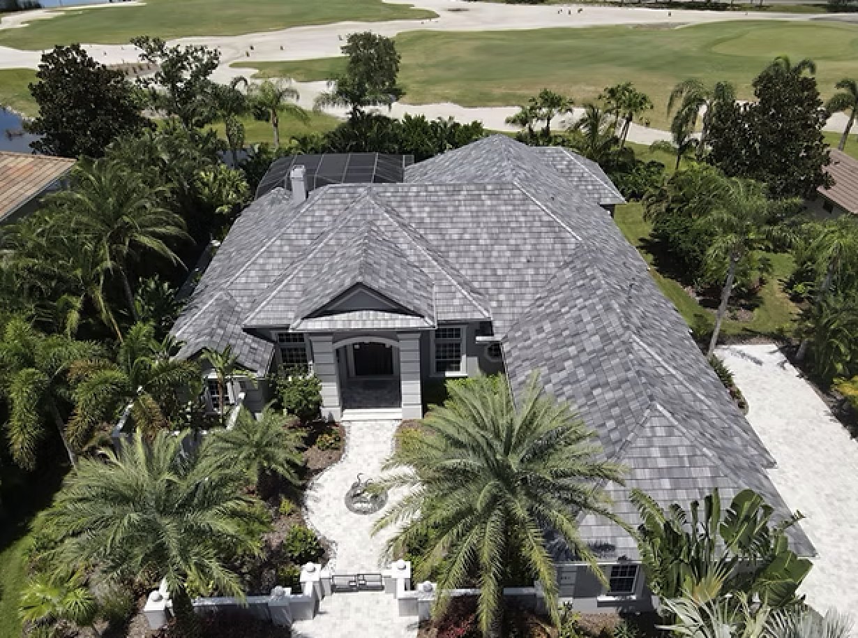 Aerial of a gray architectural shingle roof on a Wesley Chapel golf-course home with palms