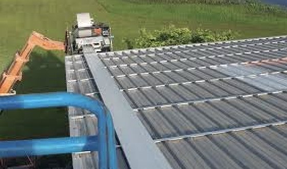 Standing-seam metal panels being mechanically seamed on a Zephyrhills roof